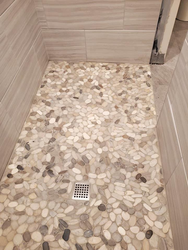 Pebble shower-floor tile and drain detail